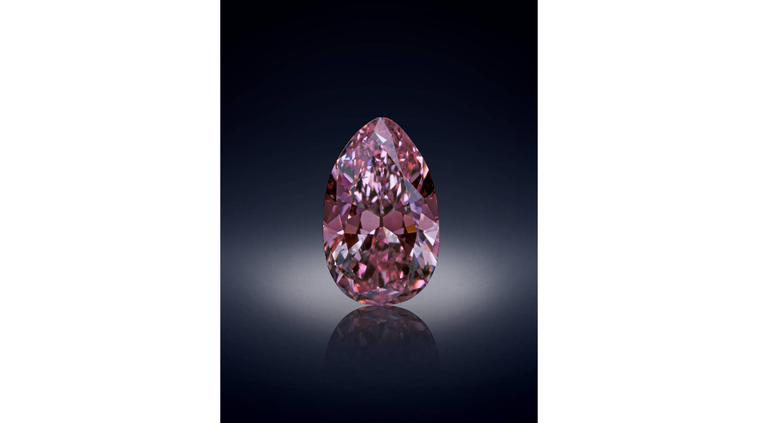 A close up photo of a large pink cut diamond