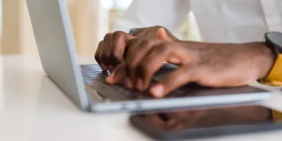 hands using keyboard of computer laptop