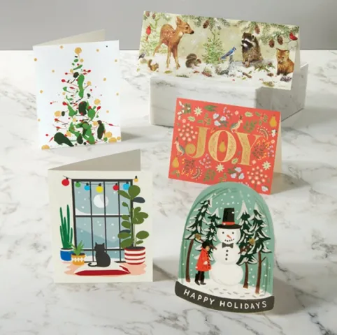 Multiple holiday cards set on a table.