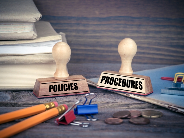 Policies and Procedures concept. Rubber Stamp on desk in the Office. Business and work background.