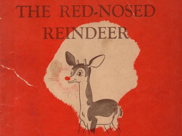 Red booklet cover with illustration of a reindeer with a red nose. Text: Rudolph the Red-Nosed Reindeer.