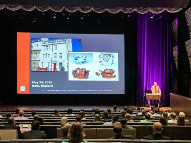 large conference room with presenter and slide