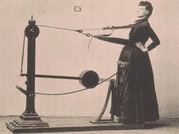 Woman exercising on 19th-century gym machine.