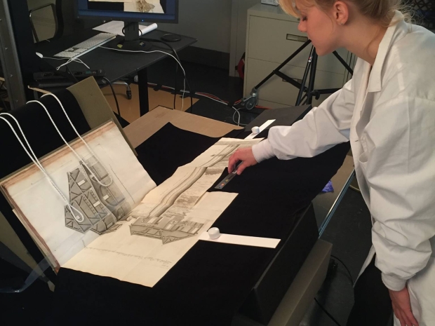 Woman digitizes an image from a book