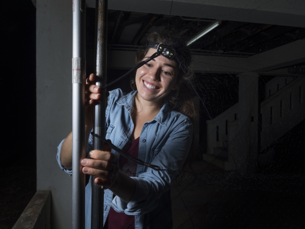 Jenna Kohles setting up a mist net to catch bats