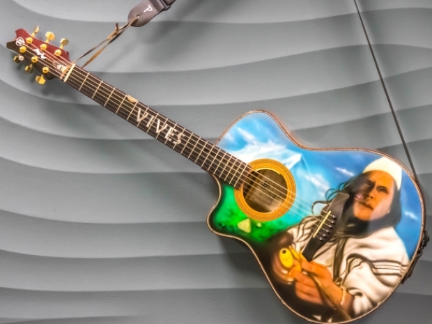 Guitar with airbrushed portrait of Carlos Vives
