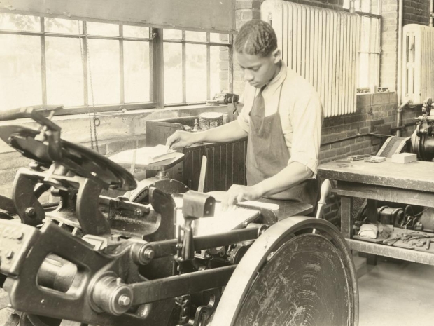 young man working at a printing press