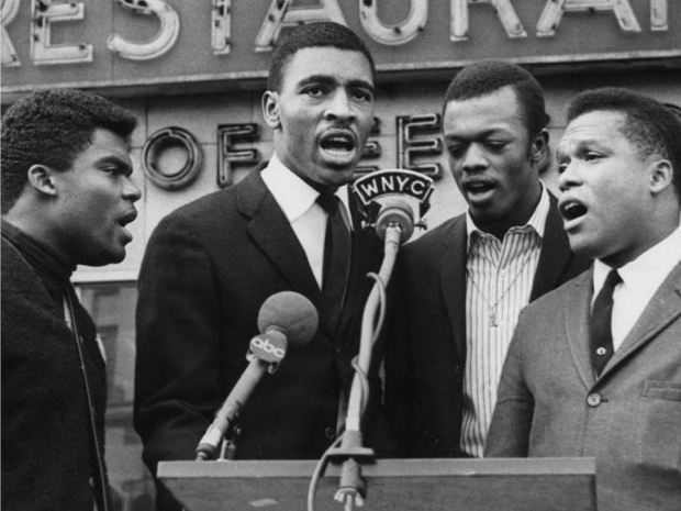 Image: The SNCC Freedom Singers performing in Harlem, 1965. Text: Grades 9–12
