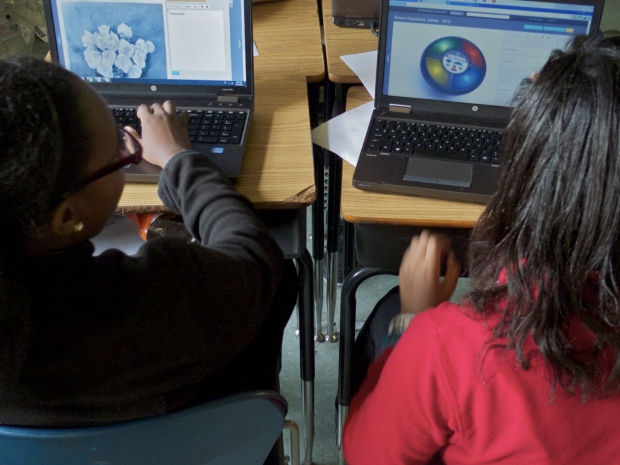 two young women using computers.