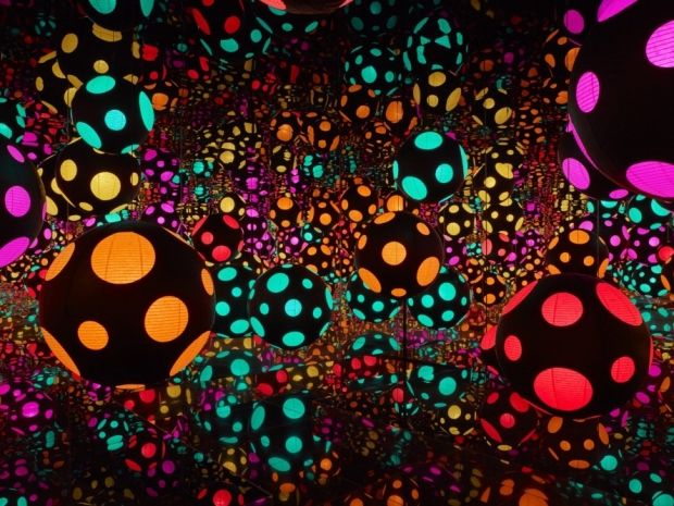 Colorful wood and glass mirrored room with paper lanterns by Yayoi Kusama.