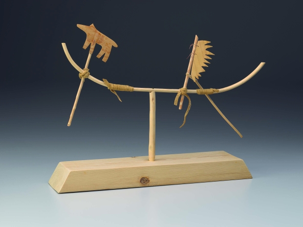 Wooden sculpture with a thick base and thin abstract shapes