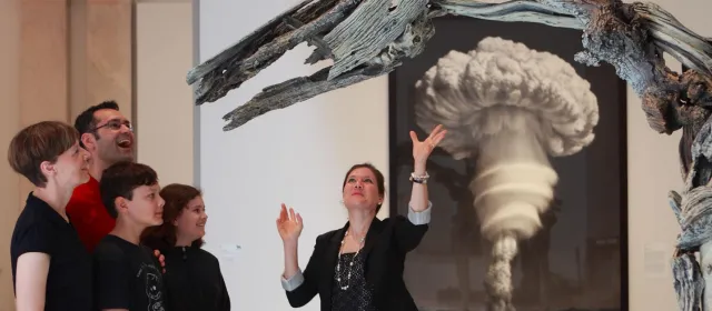 family viewing artwork with a museum docent