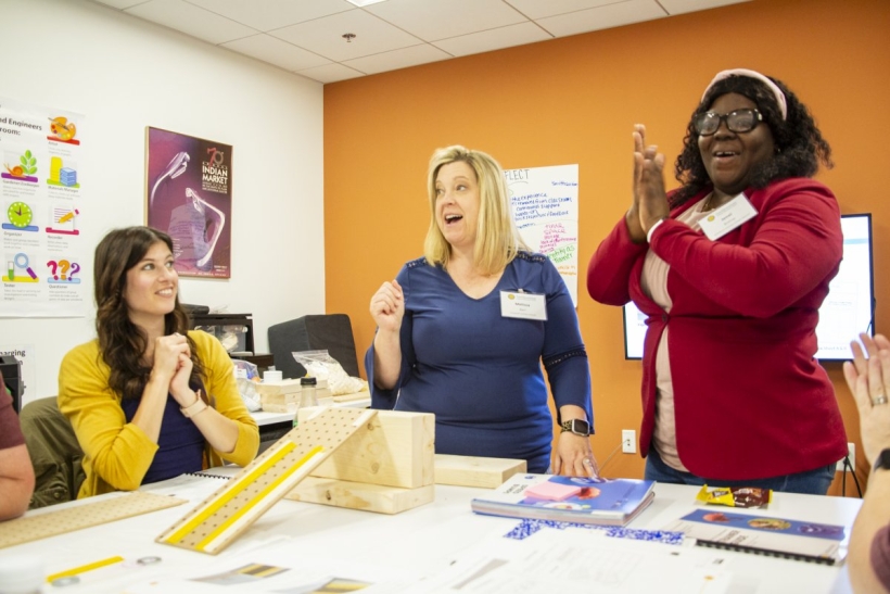 A group of educators participate in a science experiment 