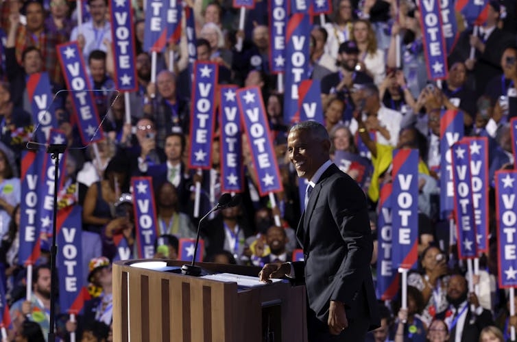 Obama at the DNC with vertical signs