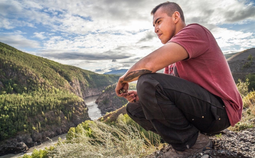 Man looks out over river valley