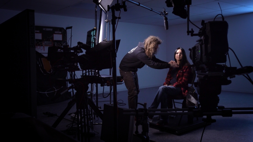 Woman being prepped for television appearance