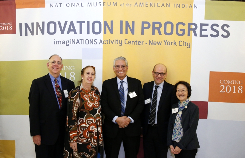 Group shot in front of Innovation in Progress banner