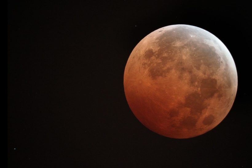 Photo of a red colored moon. 