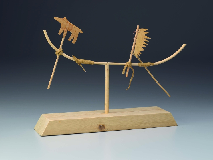 Wooden sculpture with a thick base and thin abstract shapes