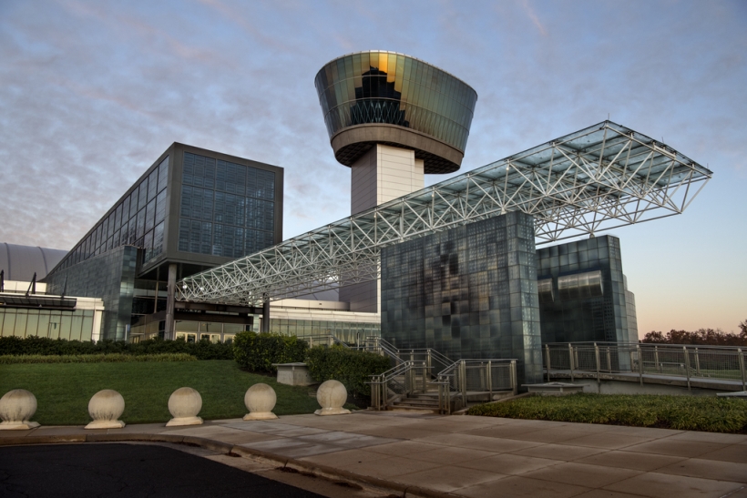 Exterior of building with large lookout tower and glass, reflective sidining.